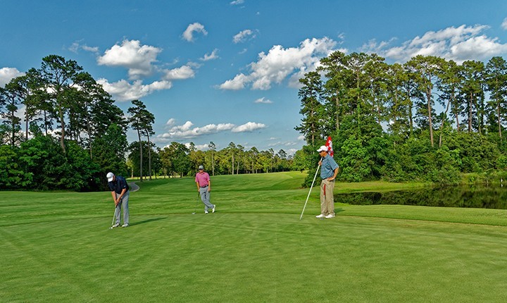 three golfers on the green at Cypresswood golf course